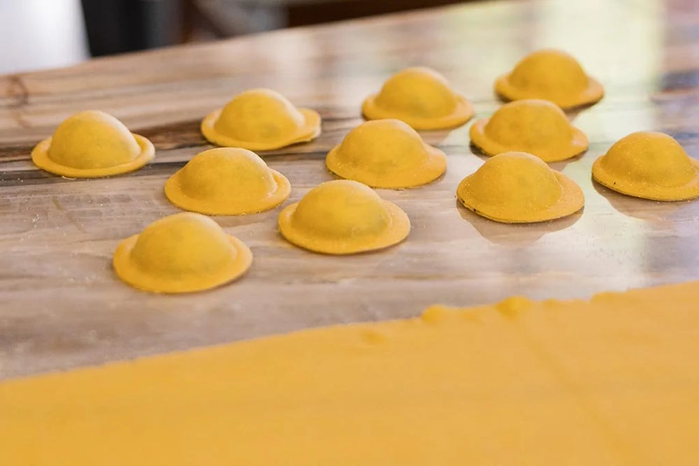 Yellow pasta ravioli on a wooden surface