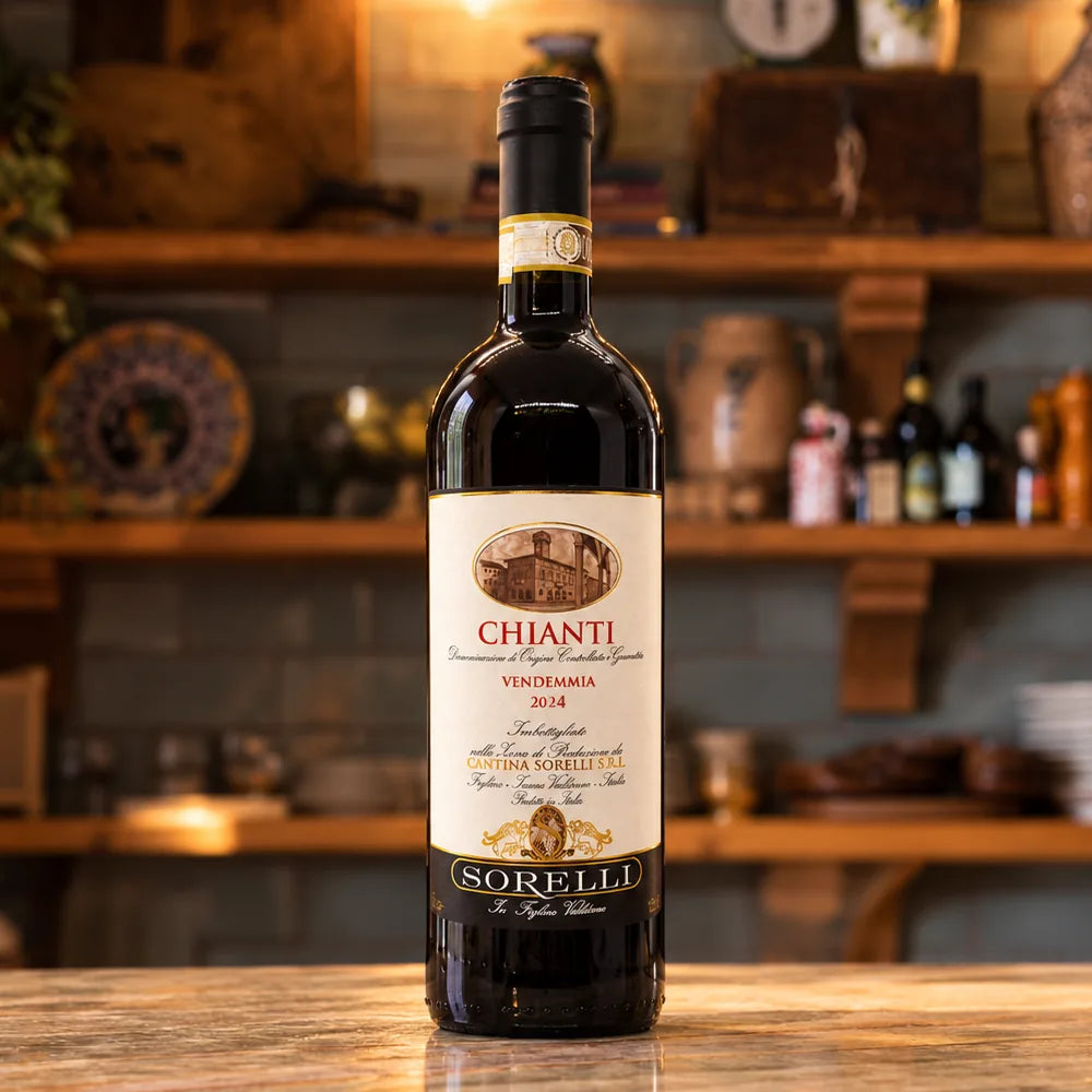 Bottle of Cantina Sorelli Chianti on a marble bar top, with wooden shelves of Italian ceramics and pantry goods behind it.