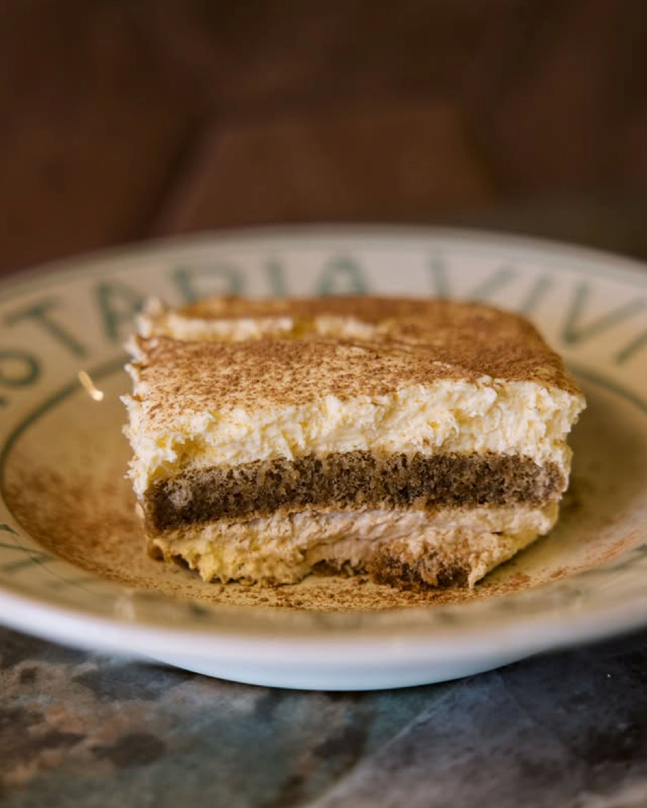 A slice of cocoa-dusted tiramisu on a Pastaria Vivi plate